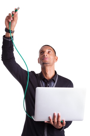 Young african american computer scientist plugin a ethernet cable, isolated on white backgroundの写真素材