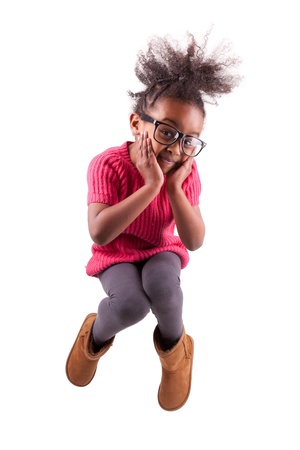 Portrait of cute Young African American girl jumping, over white backgroundの写真素材