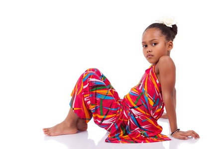Portrait of a cute young African Asian girl seated on the floorの写真素材