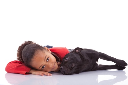 African American little girl with her pet, isolated on white backgroundの写真素材