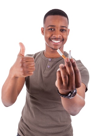 Young african american man showing  a broken  cigarette, isolated on white backgroundの写真素材