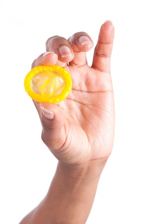 Safe sex concept  African woman Hand with condom, isolated on white backgroundの写真素材