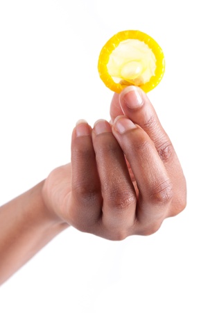 Safe sex concept  African woman Hand with condom, isolated on white backgroundの写真素材