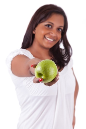 Young happy indian woman holding an apple, isolated on white backgroundの写真素材