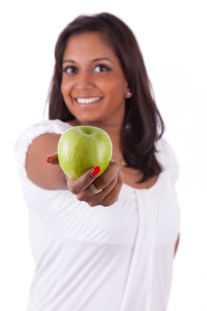 Young happy indian woman holding an apple, isolated on white backgroundの写真素材