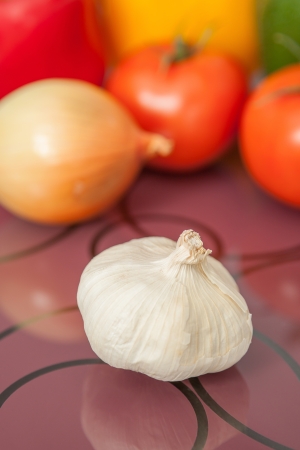 Close up of fresh garlic with fresh vegetables on backgroundの写真素材