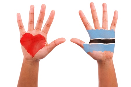 African hands with a painted heart and botswanian flag, i love botswana concept, isolated on white backgroundの写真素材