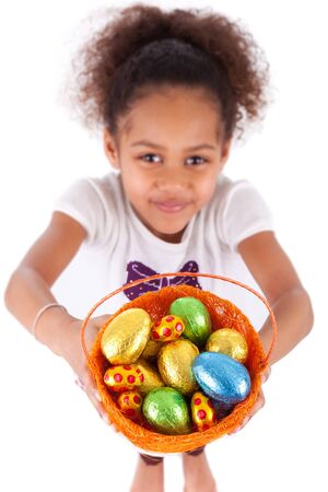 African Asian girl holding chocolate ester egg, isolated on white backgroundの写真素材