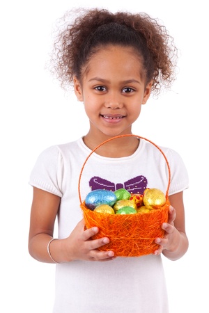 African Asian girl holding chocolate ester egg, isolated on white backgroundの写真素材