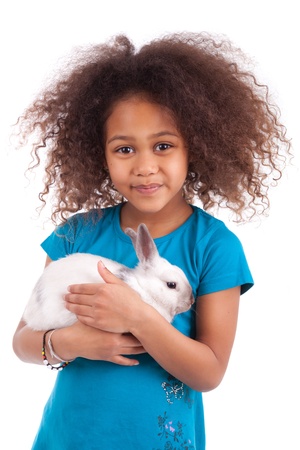 African Asian girl holding a rabbit, isolated on white backgroundの写真素材