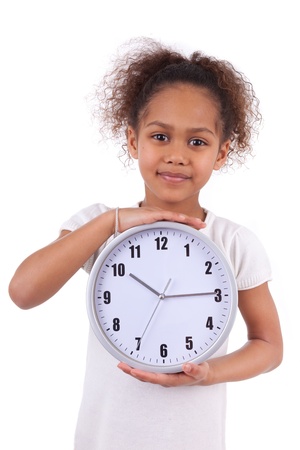 Little african asian girl holding a  clock, isolated on white backgroundの写真素材