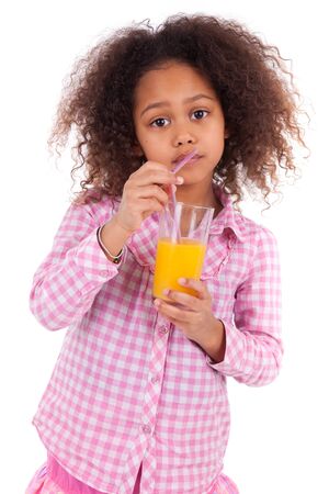 Little african asian girl drinking orange juice,isolated on white backgroundの写真素材