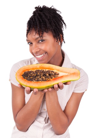 Young happy black / african american woman holding fresh papaya isolated on white backgroundの写真素材