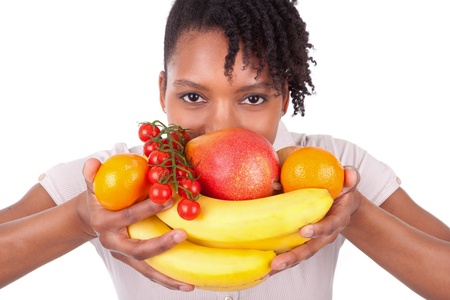 Young happy black / african american woman holding fresh fruits isolated on white backgroundの写真素材