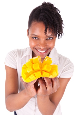 Young happy black / african american woman holding fresh mango isolated on white backgroundの写真素材