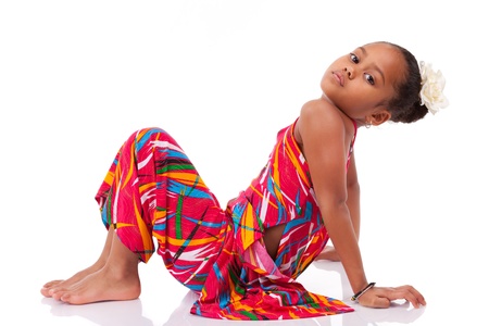 Portrait of a cute young African Asian girl seated on the floorの写真素材