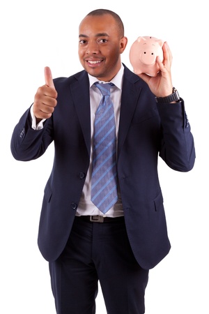 African American business man holding a piggy bank making thumbs up, isolated on white background - African peopleの写真素材
