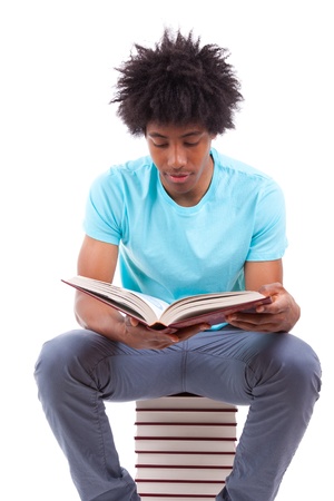 Young black teenage student men reading a books, isolated on white background - African peopleの写真素材