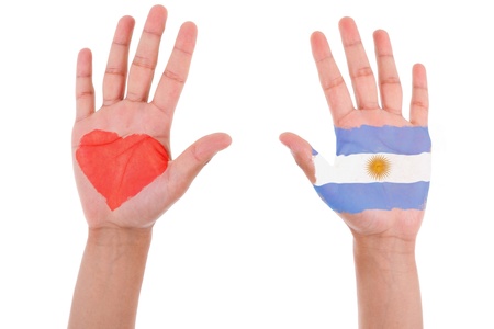 Hands with a painted heart and argentinian flag, i love argentina concept, isolated on white backgroundの写真素材