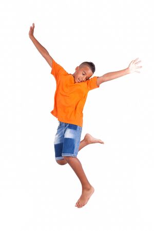 Portrait of a cute teenage black boy jumping over white background - African peopleの写真素材