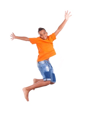 Portrait of a cute teenage black boy jumping over white background - African peopleの写真素材