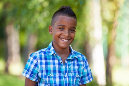 Outdoor portrait of a cute teenage black boy - African peopleの写真素材