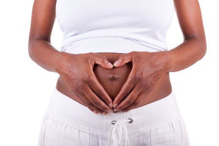 Young pregnant black woman touching her belly, isolated on white background - African peopleの写真素材