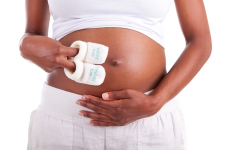 Young pregnant black woman touching her belly, isolated on white background - African peopleの写真素材