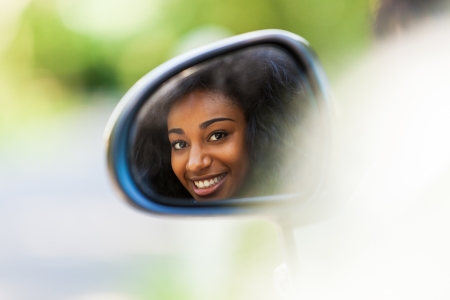 Young black teenage driver seated in her new convertible car - African peopleの写真素材