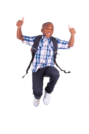 African American school boy jumping and making thumbs up , isolated on white background - Black peopleの写真素材