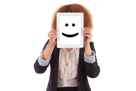 African American business woman holding a tactile tablet displaying a smiling emoticon, isolated - Black peopleの写真素材