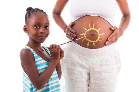 Little african american girl painting on her mother's belly, isolated on white background - African peopleの写真素材
