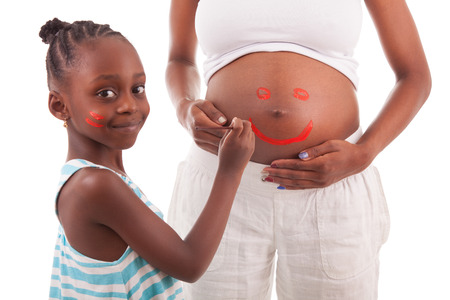 Little african american girl painting on her mother's belly, isolated on white background - African peopleの写真素材