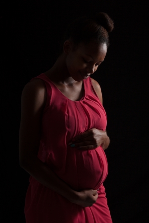 Pregnant African American woman , over black - Black peopleの写真素材