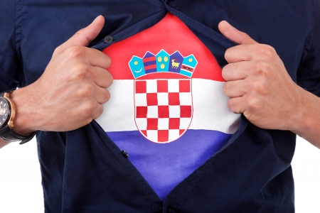 Young sport fan opening his shirt and showing the flag his country Croatia, Croatian flagの写真素材