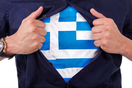 Young sport fan opening his shirt and showing the flag his country Greece, Greek flagの写真素材