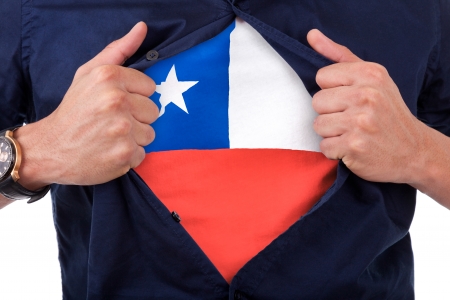 Young sport fan opening his shirt and showing the flag his country Chili, Chilean flagの写真素材