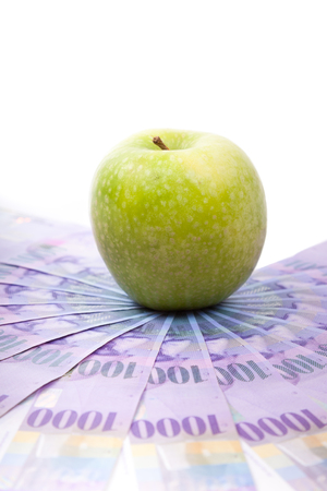 Green apple on Swiss francs banknotes  spreaded over the floor - Switzerland currencyの写真素材