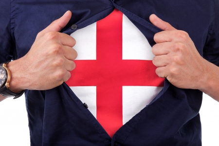 Young sport fan opening his shirt and showing the flag his country england, English flagの写真素材