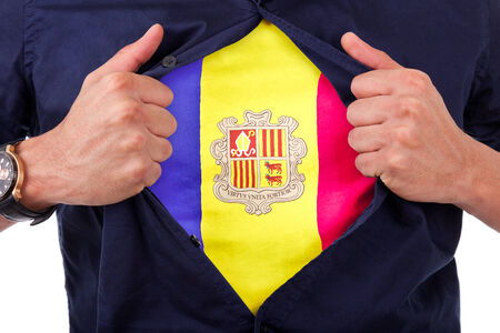 Young sport fan opening his shirt and showing the flag his country Andorra, Andorran flagの写真素材