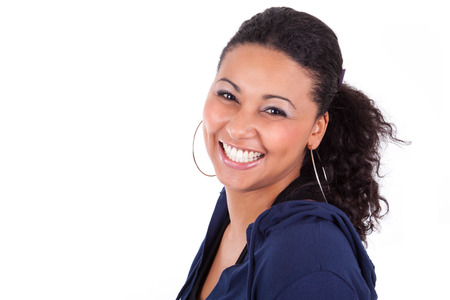 Portrait of a young African American woman holding her head, isolated on white backgroundの写真素材