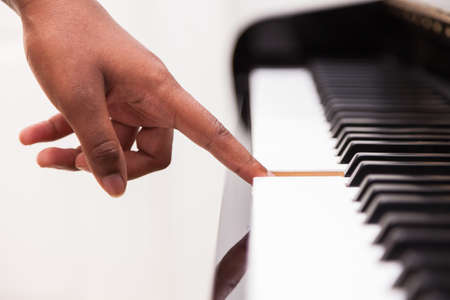 African American hand playing piano  - Touching piano keys - Black peopleの写真素材