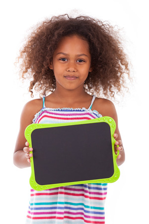 African American school girl holding a blank  black board, isolated on white background - Black peopleの写真素材