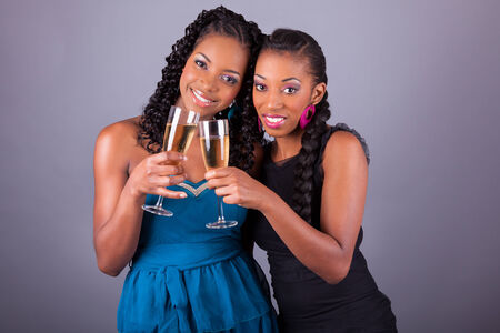Young beautiful African American womans holding a glass of champagneの写真素材