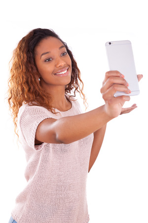 Young African American woman taking a selfie - self portrait - Black teenager peopleの写真素材