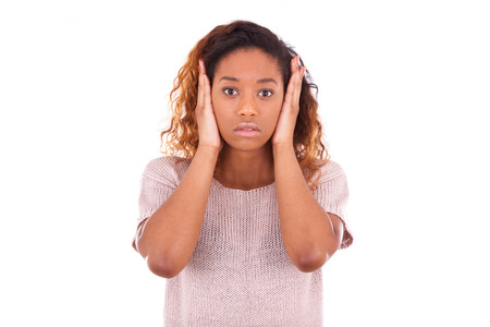 young african american covering her ears with her hands isolated on white backgroundの写真素材