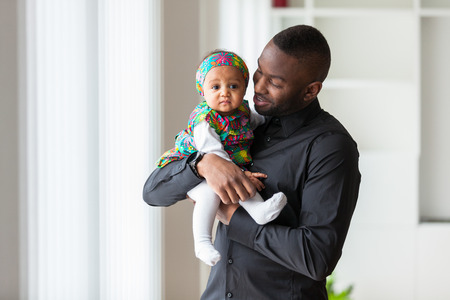 Young african american father holding with her baby girlの写真素材