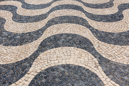 Typical portuguese cobblestone hand-made pavement calÃ§ada in Lisbon, Portugal