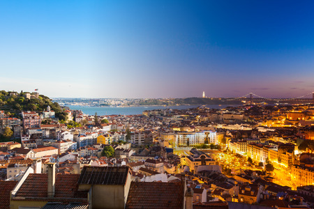 Aerial view montage of Lisbon rooftop from Senhora do Monte viewpoint (Miradouro)  fromn day to night in Portugalの写真素材