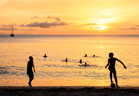 Childrens silhouette playing soccer at Tarrafal beach in Santiago island in Cape Verde - Cabo Verdeの写真素材